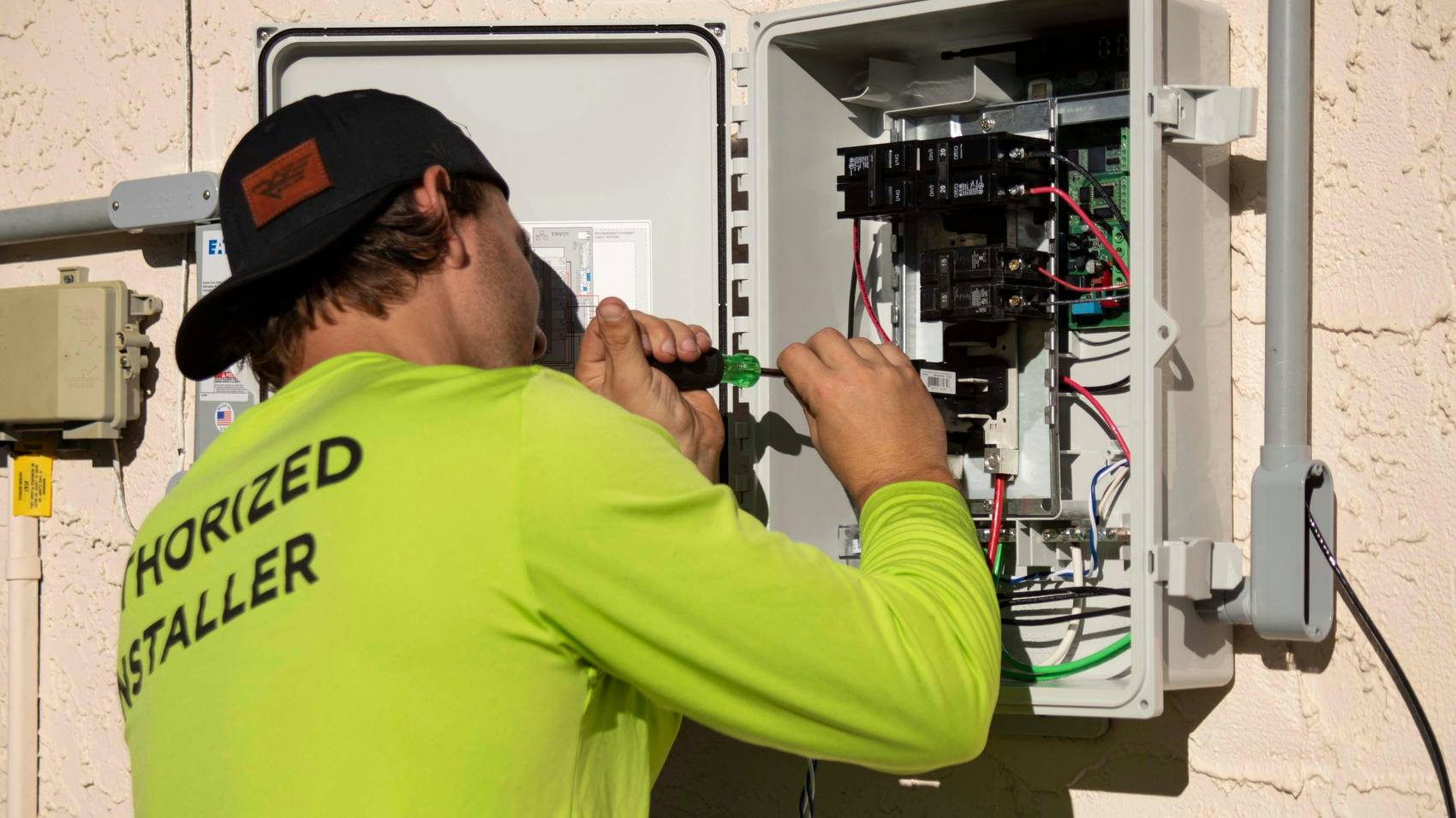 Electrician testing circuits inside an outdoor distribution board